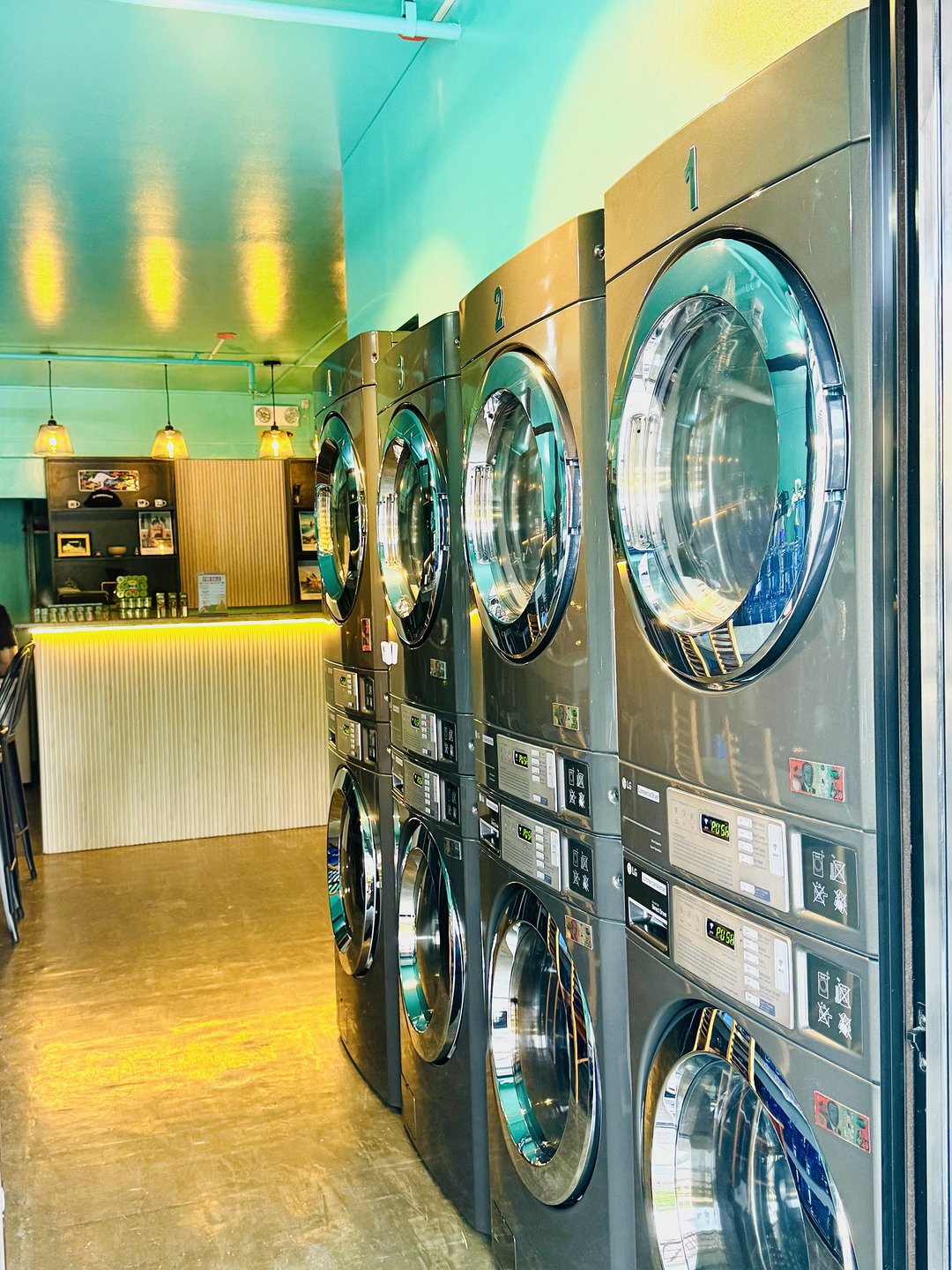 Row of stacked front-loading laundry machines inside Freshflow