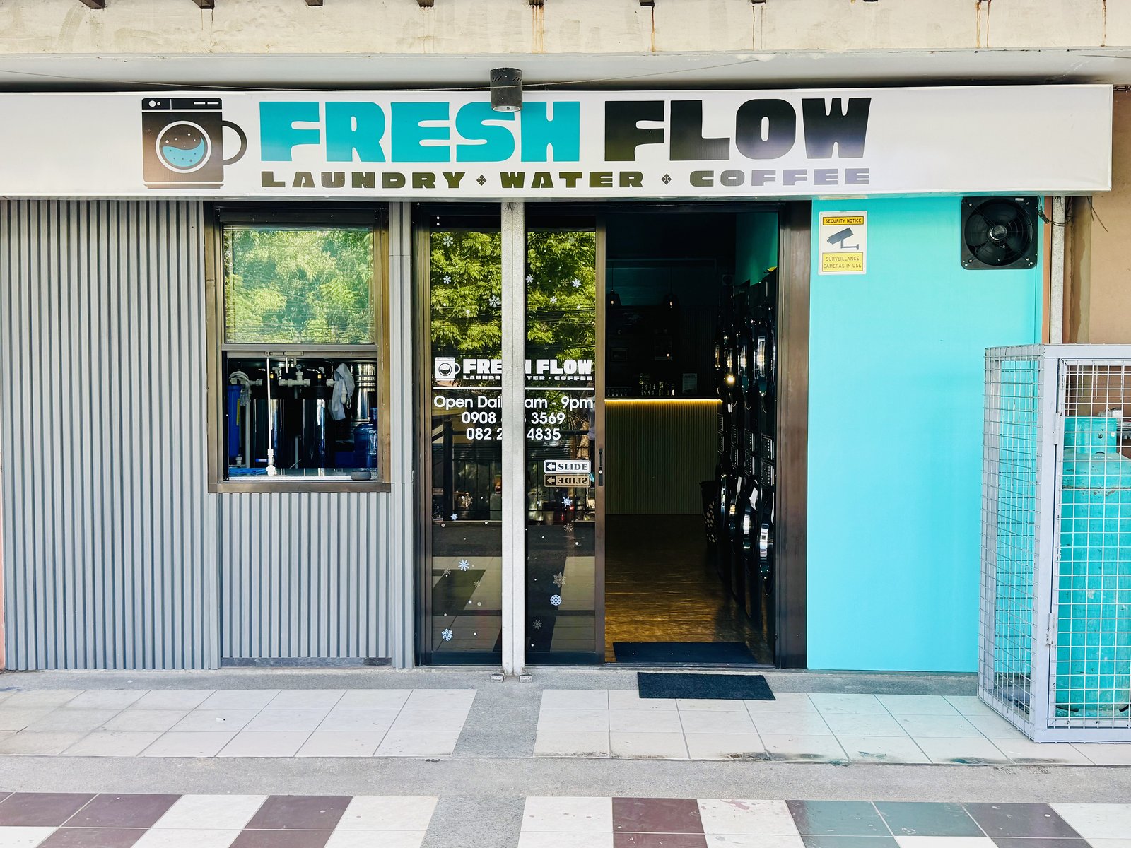 Freshflow storefront with Laundry, Water and Coffee signage above the entrance